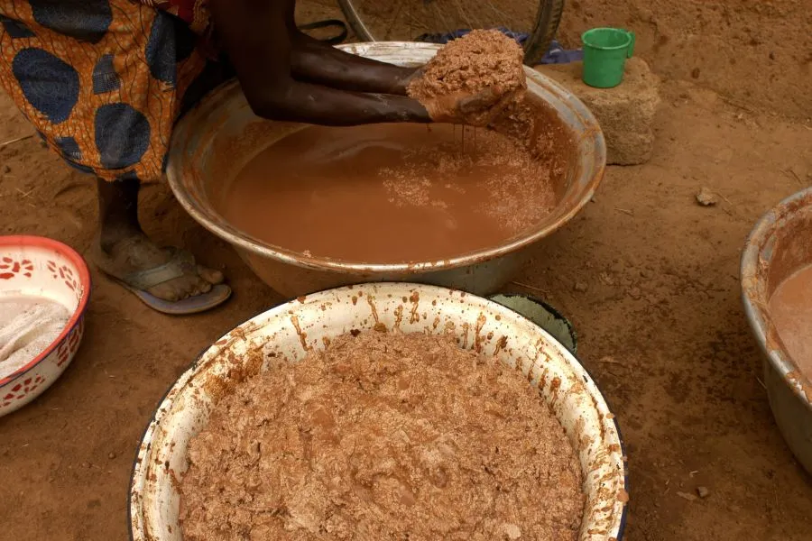 A woman's hands creating shea butter.